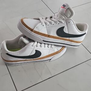 Nike Kids White and Black Sneakers with Gold Accents